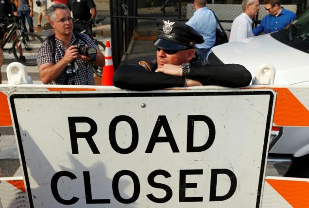 A police officer leans against a sign along a downtown street during a march by various groups including Black Lives Matter and Shut Down Trump and the RNC REUTERSLucas Jackson