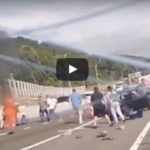 Truck crashes into traffic men pull woman out of burning car
