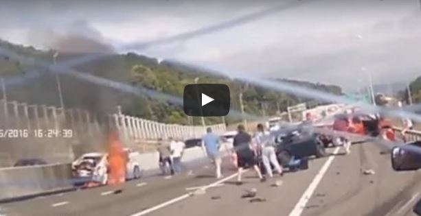Truck crashes into traffic men pull woman out of burning car