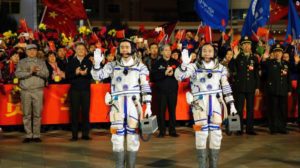 China's longest space mission launches 2 (Chinese astronauts Jing Haipeng, right, and Chen Dong, left, wave farewell to the crowd before getting on Shenzhou 11 on Oct. 17, 2016.)