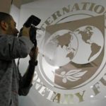 A photographer takes pictures through a glass carrying the International Monetary Fund IMF logo during a news conference in Bucharest file REUTERSBogdan Cristel