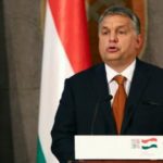 Hungarys PM threatens to sue EU over mandatory migrant quotas