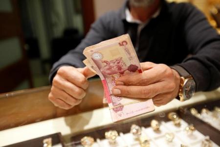 Libyan officials squabble residents protest as cash crisis hits home