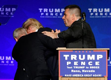 Security hustles Trump from stage after protester displays sign