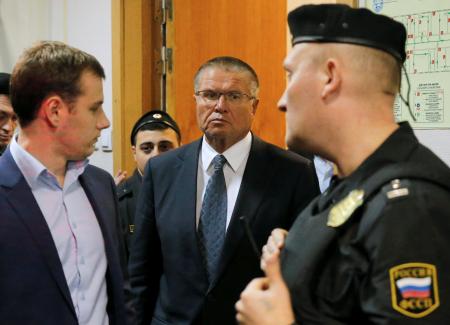 Russias Putin fires economy minister over bribery charges