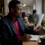 Nigerian worker reading minimum wage document