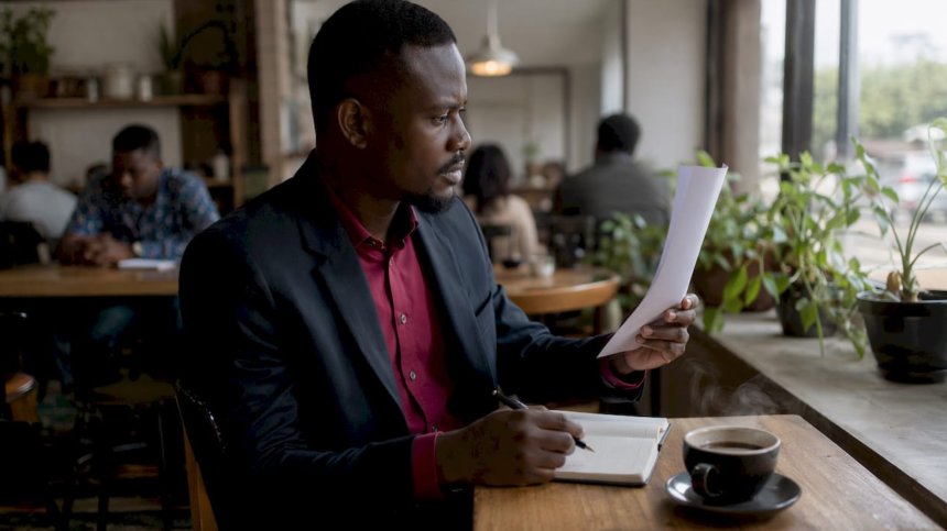 Nigerian worker reading minimum wage document