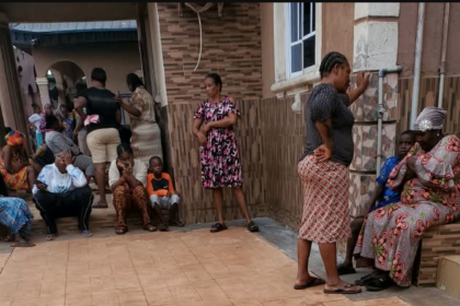 Neighbours gather in shock at Ozoekwe Ezeudu's compound in Mgbakwu -Photo: Uche Ndeke/Radio Nigeria
